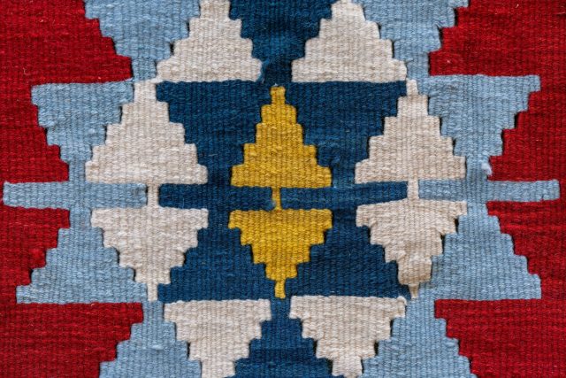 Close-up of a traditional colorful Turkish Kilim with geometric patterns in Antalya.