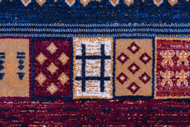 Closeup of a colorful Turkish rug showcasing intricate traditional patterns and vibrant textures.