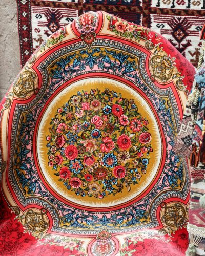 Colorful Persian rugs and textiles gallery showcasing intricate patterns and vibrant designs.